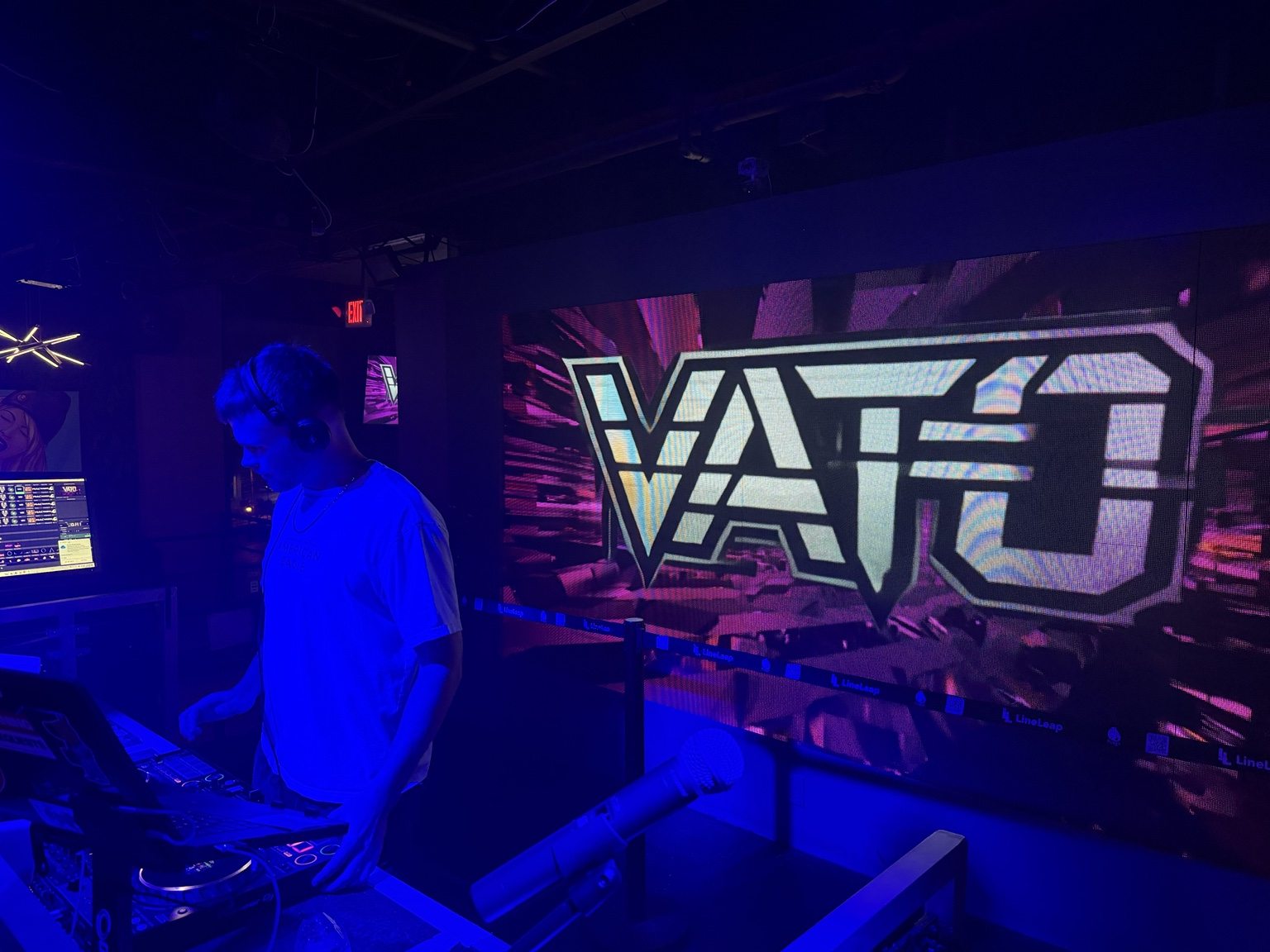 VATO performing beside his venue LED identity